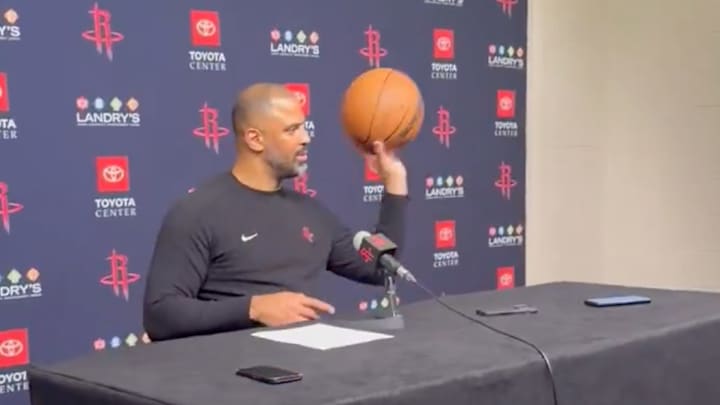 Ime Udoka throws a basketball to Houston Chronicle Jonathan Feigen to celebrate his retirement.