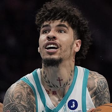 Oct 30, 2025; Charlotte, North Carolina, USA;  Charlotte Hornets guard LaMelo Ball (1) drives to the basket against Orlando Magic guard Anthony Black during the second half at Spectrum Center. Mandatory Credit: Jim Dedmon-Imagn Images