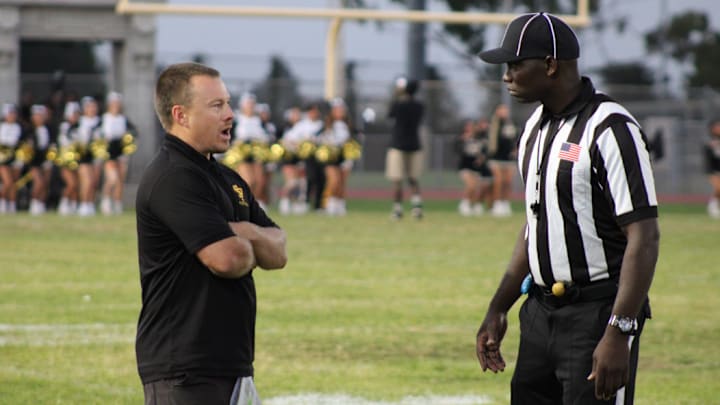 San Pedro football coach Corey Walsh talks to an official before his team takes on Garfield on Friday, Sept. 13, 2024.