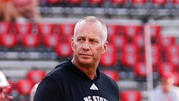 Aug 28, 2025; Raleigh, North Carolina, USA; North Carolina State Wolfpack head coach Dave Doeren walks among his players during the warmups prior to the game against East Carolina Pirates at Carter-Finley Stadium. Mandatory Credit: Jaylynn Nash-Imagn Images
