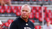 Aug 28, 2025; Raleigh, North Carolina, USA; North Carolina State Wolfpack head coach Dave Doeren walks among his players during the warmups prior to the game against East Carolina Pirates at Carter-Finley Stadium. Mandatory Credit: Jaylynn Nash-Imagn Images