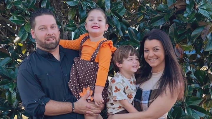Nature Coast football head coach Robert Kazmier holding his daughter Kennedy, 5, while his wife Carrie holds their son Sawyer, 3. Nature Coast football head coach Robert Kazmier holding his daughter Kennedy, 5, while his wife Carrie holds their son Sawyer, 3.