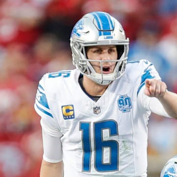 Detroit Lions quarterback Jared Goff (16) talks to center Frank Ragnow (77) before a snap against the 49ers