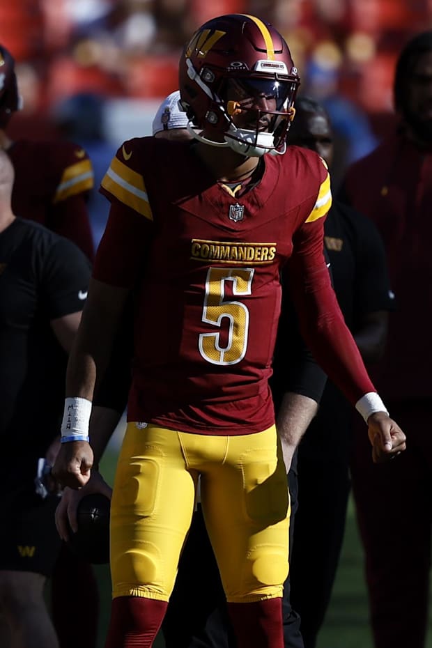Washington Commanders quarterback Jayden Daniels (5) stands on the field