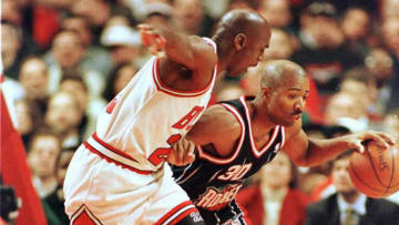 Houston Rockets guard Kenny Smith tries to drive against Michael Jordan of the Chicago Bulls