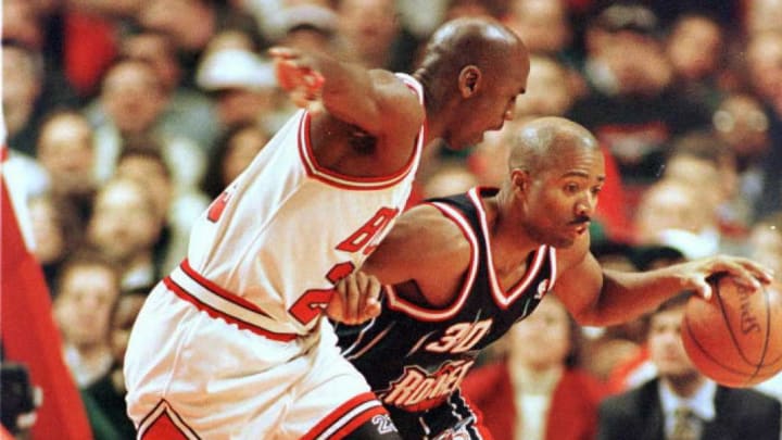 Houston Rockets guard Kenny Smith tries to drive against Michael Jordan of the Chicago Bulls