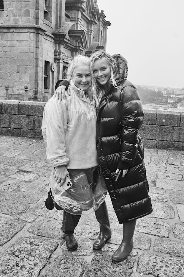 SI Swimsuit editor in chief MJ Day and model Camille Kostek pose in the rain during a photo shoot for the 2024 magazine.