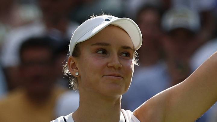 Elena Rybakina waves to the crowd after a match
