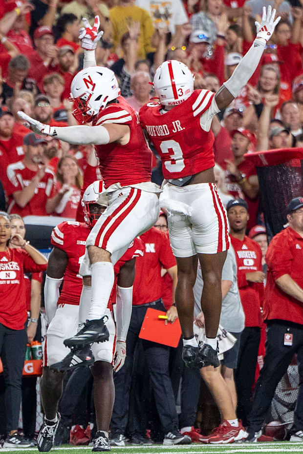 Nebraska defenders John Bullock and Marques Buford Jr. celebrate after forcing a Colorado turnover on downs.