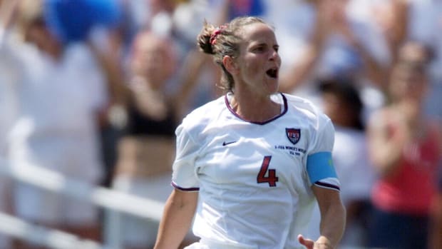 Carla Overbeck leaps in the air after hitting the first penalty shot in the USA's win over China in the Women's World Cup.