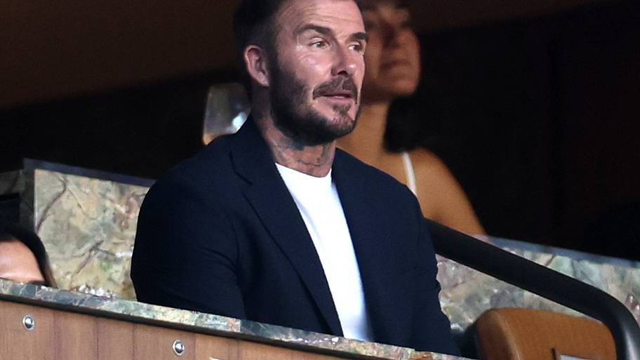 David Beckham looking on.
