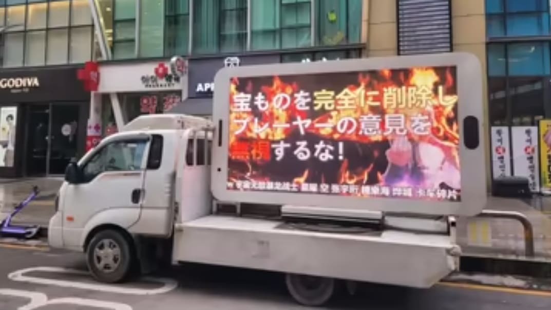 Photo showing a truck carrying a digital billboard with a protest message.