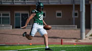 Trevor Allen is shown punting at Adams State.