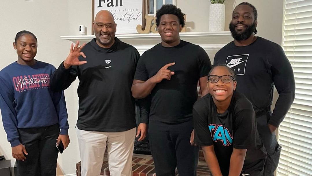 Kansas State defensive line coach Buddy Wyatt, Johnnie Fitzgerald, and his family during a home visit. Kansas State defensive line coach Buddy Wyatt, Johnnie Fitzgerald, and his family during a home visit.