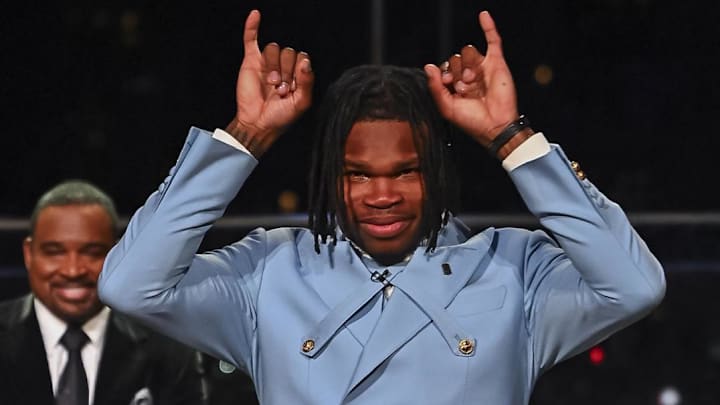 Who is Travis Hunter's dad who missed the Heisman Trophy ceremony?