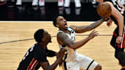 May 27, 2021; Miami, Florida, USA; Milwaukee Bucks guard Jeff Teague (5) drives past Miami Heat center Bam Adebayo (13) in the second half during game three in the first round of the 2021 NBA Playoffs at American Airlines Arena. 