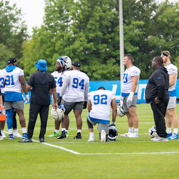 Detroit Lions defense talks during training camp practice.