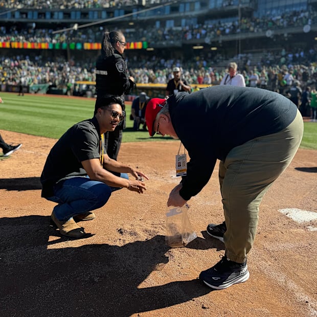 A’s fans gather dirt from the team’s final game in Oakland.