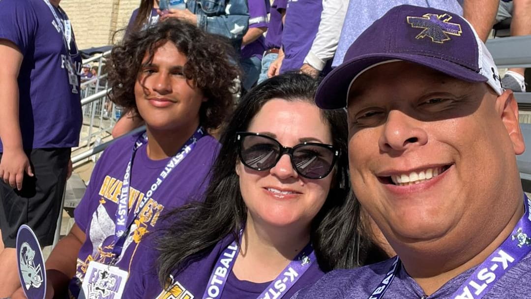 Micah Santiago (L) and his parents at the Wildcats game. /@_santiago_micah/X