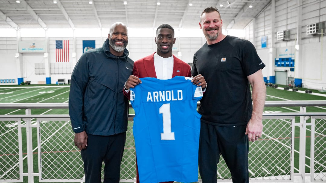 Detroit Lions general manager Brad Holmes, first-round pick Terrion Arnold and head coach Dan Campbell pose for a photo.