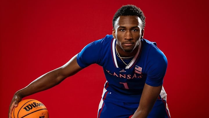 Darryn Peterson, wearing a vibrant Kansas Jayhawks blue uniform. The uniform features the team's iconic blue and red color scheme, with "Kansas" prominently displayed across the chest in bold white letters.