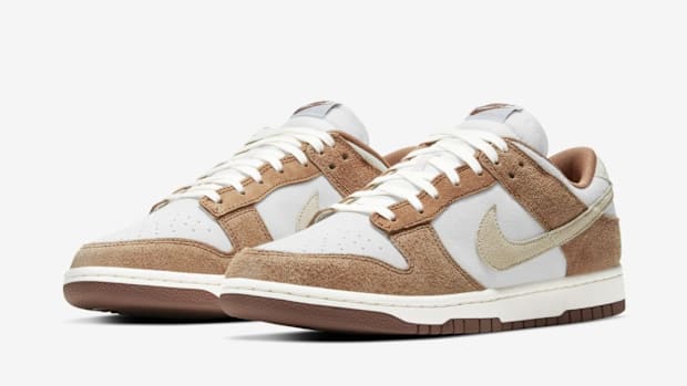 Tan and white Nike Dunk Low sneakers.