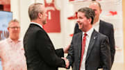 New Indiana basketball coach Darian DeVries (left) shakes hands with Indiana athletic director Scott Dolson.