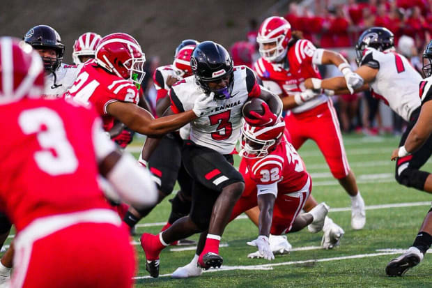 Corona Centennial running back Malachi Roby bursts through the Mater Dei defense on Thursday, Aug. 22, 2024.