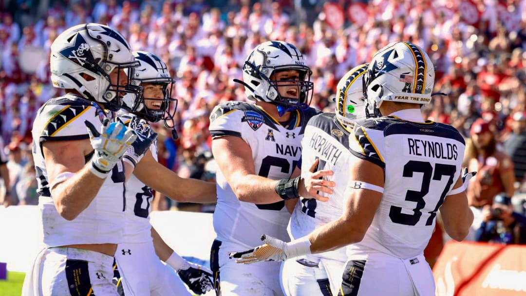 Navy football players celebrate winning the Armed Forces Bowl over Oklahoma