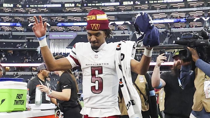 Jan 5, 2025; Arlington, Texas, USA;  Washington Commanders quarterback Jayden Daniels (5) waves to fans after the game against the Dallas Cowboys at AT&T Stadium. Mandatory Credit: Kevin Jairaj-Imagn Images