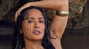 Salma Hayek Pinault was photographed by Ruven Afanador in Mexico. Swimsuit by Alameda Turquesa. Body chain by Baby Gold. Cuff by JUJU VERA.