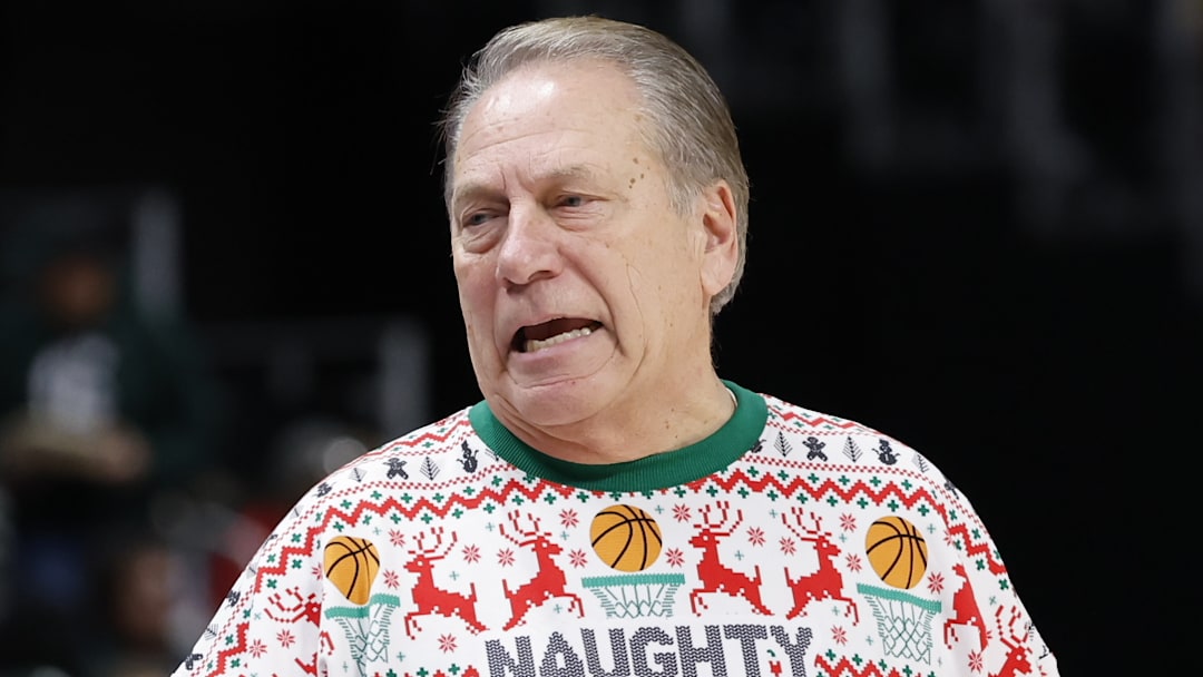 Michigan State Spartans head coach Tom Izzo patrols the sidelines wearing an ugly Christmas sweater depicting him yelling at a referee with "Naughty List" written on it during a game against the Oakland Golden Grizzlies at Little Caesars Arena on Saturday, Dec. 20, 2025.