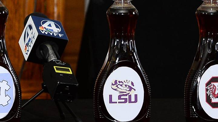 LSU Tigers and South Carolina football logos on maple syrup bottles from a commitment ceremony back in 2023.