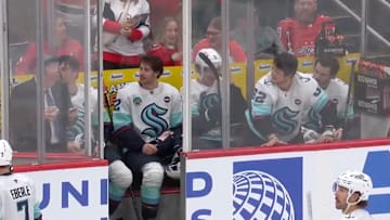 Five players from the Seattle Kraken sit in the penalty box against the Washington Capitals.
