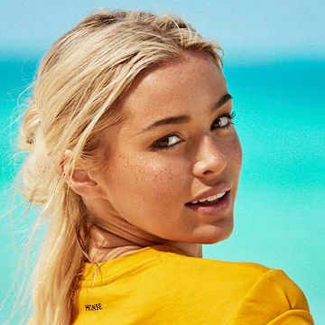 Olivia Dunne was photographed by Ben Watts in Bermuda. Shirt by MONSE.