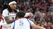 Arkansas Razorbacks guard Boogie Fland makes a pass defended by Kansas Jayhawks Zeke Mayo at Bud Walton Arena in Fayetteville, Ark.