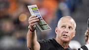 Sep 7, 2024; Charlotte, North Carolina, USA; North Carolina State Wolfpack head coach Dave Doeren talks with officials during the first quarter against the Tennessee Volunteers at the Dukes Mayo Classic at Bank of America Stadium. Mandatory Credit: Jim Dedmon-Imagn Images