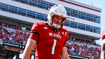 Oct 4, 2025; Raleigh, North Carolina, USA; NC State Wolfpack quarterback CJ Bailey (11), linebacker Caden Fordham (1), wide receiver Keenan Jackson (8) and offensive lineman Jr. Anthony Carter (75) walk out for the coin toss prior to the first half of the game against Campbell Fighting Camels at Carter-Finley Stadium. Mandatory Credit: Jaylynn Nash-Imagn Images