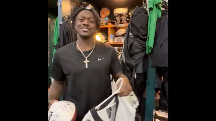 A.J. Brown holds up a signed jersey.