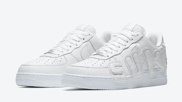 White Nike Air Force 1 sneakers.