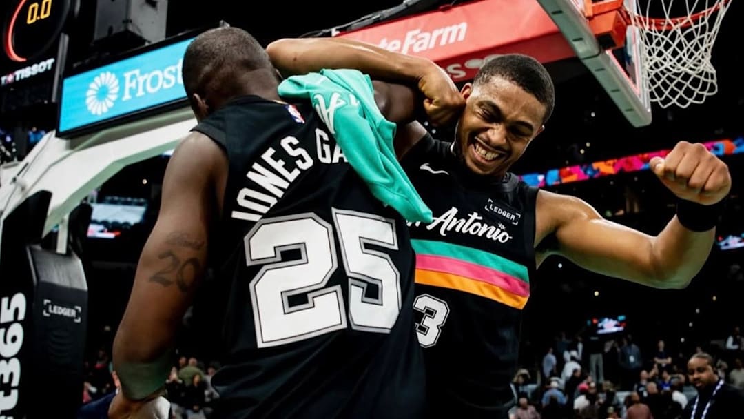 Nov 20, 2025; San Antonio, Texas, USA; San Antonio Spurs point guard David Jones Garcia (25) celebrates with forward Keldon Johnson (3) after a win over the Atlanta Hawks at Frost Bank Center.