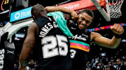 Nov 20, 2025; San Antonio, Texas, USA; San Antonio Spurs point guard David Jones Garcia (25) celebrates with forward Keldon Johnson (3) after a win over the Atlanta Hawks at Frost Bank Center.