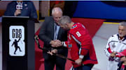 Alex Ovechkin receives a gold hockey stick during a celebration of his NHL goals record. 