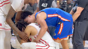Walter Clayton Jr. consoles Emmanuel Sharp after the national title game. 