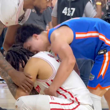 Walter Clayton Jr. consoles Emmanuel Sharp after the national title game. 