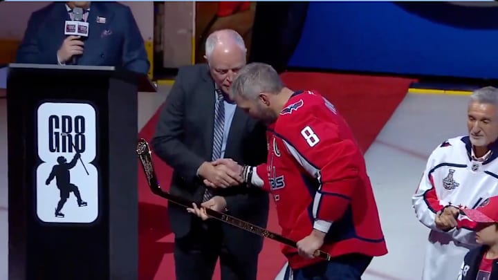 Alex Ovechkin receives a gold hockey stick during a celebration of his NHL goals record. Alex Ovechkin receives a gold hockey stick during a celebration of his NHL goals record.