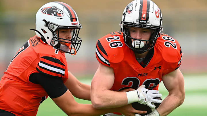 Half Moon Bay QB Dusty Dimas (7) hands ball to RB Adler Halterman (26) during a Sept. 20 game versus Woodside, a 43-29 Cougars win. 