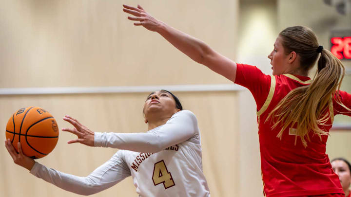 Mission Hills guard Bayanai Cordova attempts to get the ball over a Fallbrook during a Jan. 25 game won by the Grizzlies 93-55. 