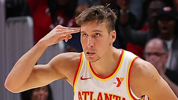 Bogdan Bogdanovic #13 of the Atlanta Hawks reacts after a basket against the Philadelphia 76ers.