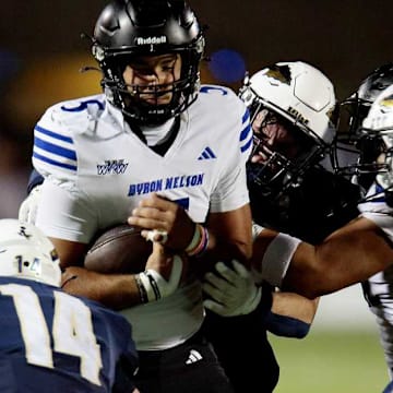 Trophy Club Byron Nelson quarterback Parker Almanza is tackled by a trio of Keller defenders in a game on Oct. 9. 